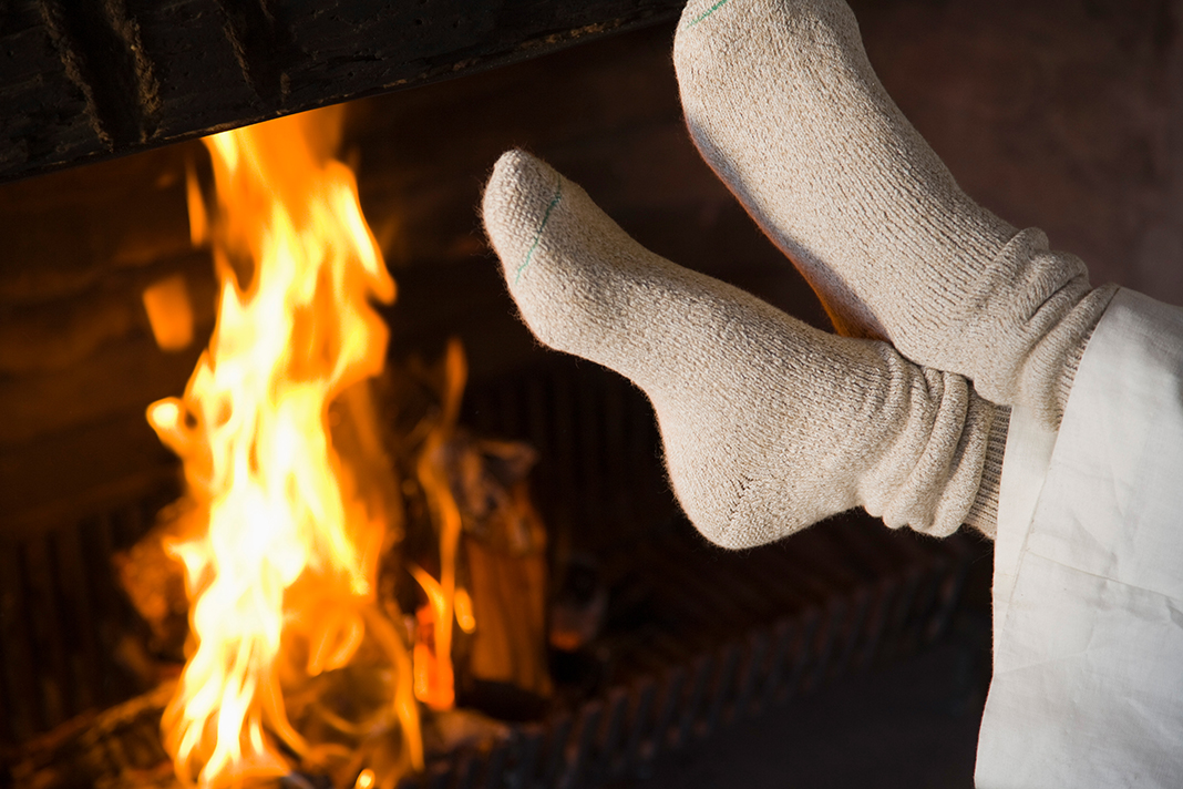 Feet by fireplace